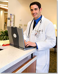 Image of a Doctor working on a Laptop